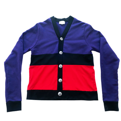 The Chromatic Horizon Cardigan by Mariano features bold purple, navy, and red color blocks—crafted for comfort, individuality, and modern elegance.