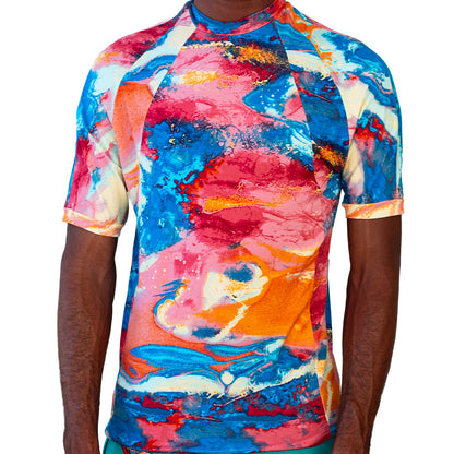 Multicolor Mariano performance tee with watercolor print in blue, pink, and yellow tones.