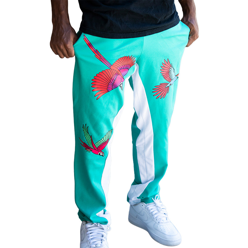 Turquoise Mariano track pants with red and blue bird prints and white side panels in a slim athletic fit.