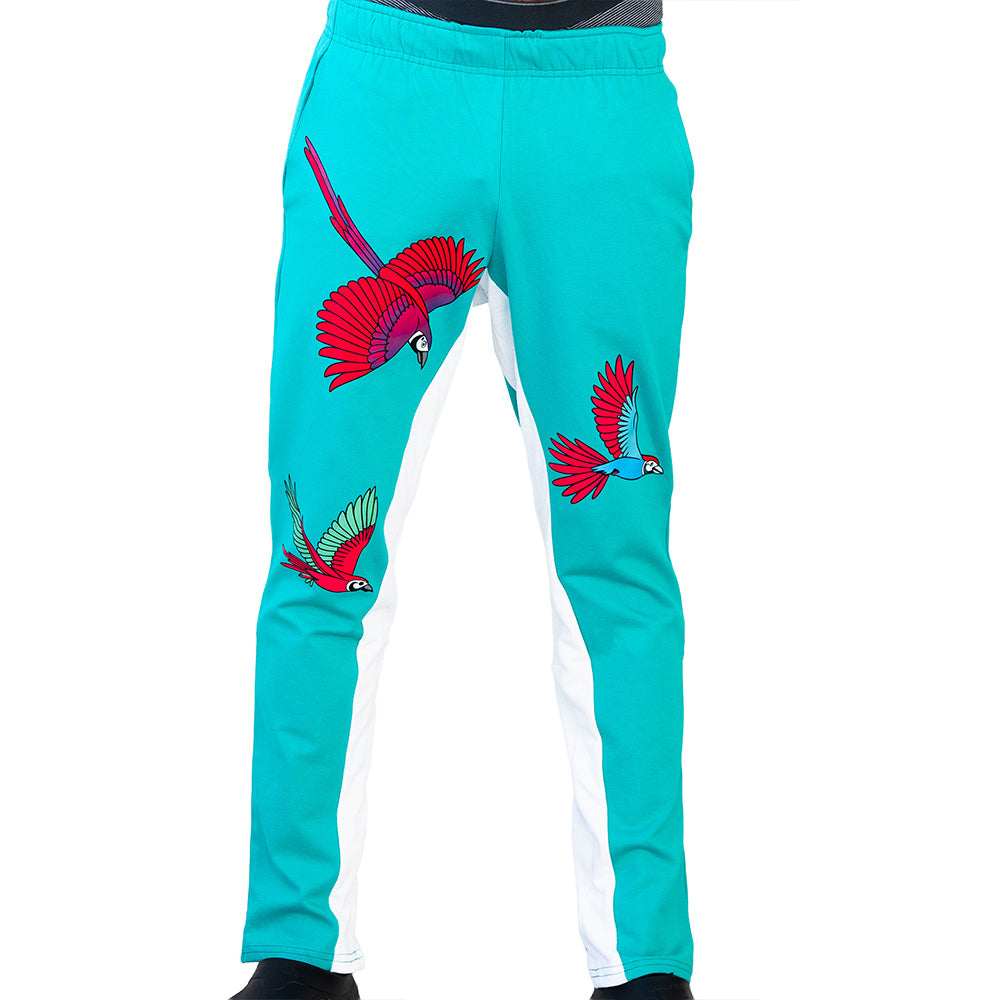 Turquoise Mariano track pants with red and blue bird prints and white side panels in a slim athletic fit.