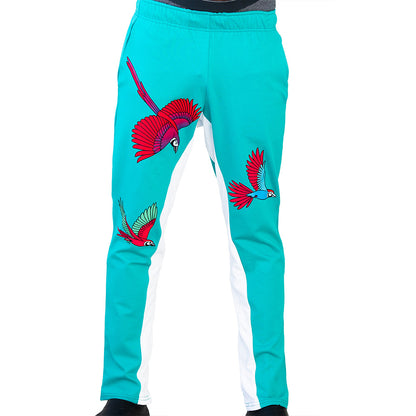 Turquoise Mariano track pants with red and blue bird prints and white side panels in a slim athletic fit.